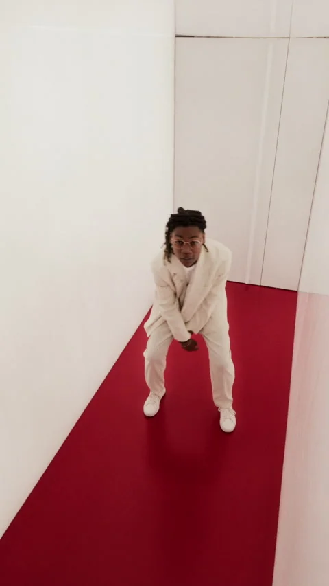 Vertical Portrait of Young Black Man Dancing in White Minimalist Corridor Stock Footage 337404955