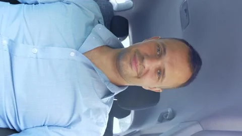 Vertical portrait of young handsome man showing thumbs up while sitting in car Stock Footage 142229513