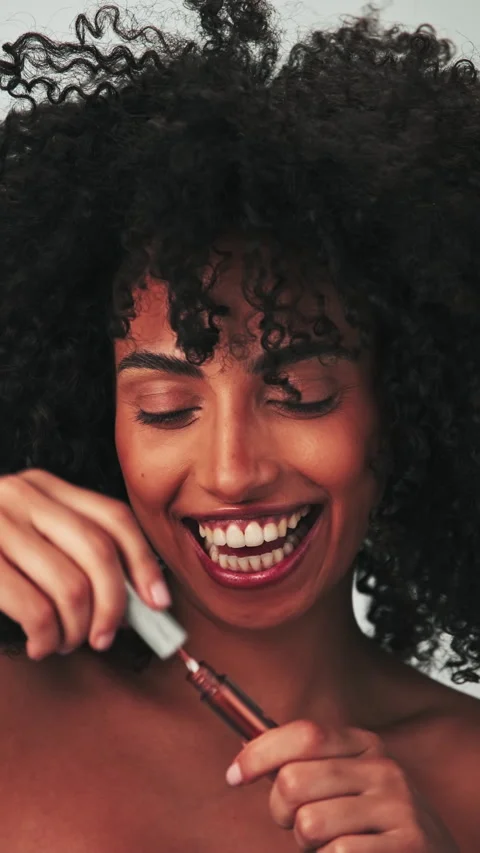 Vertical portrait of a young model with dreary afro hair and bright makeup Stock Footage 270907936