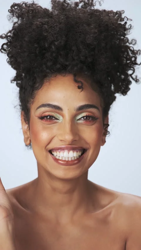 Vertical portrait of a young model with dreary afro hair and bright makeup Stock Footage 310429386