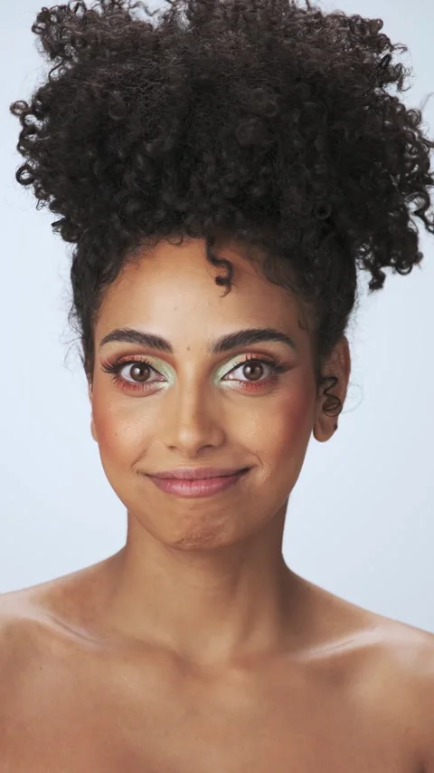 Vertical portrait of a young model with dreary afro hair and bright makeup. Stock Footage 340072207