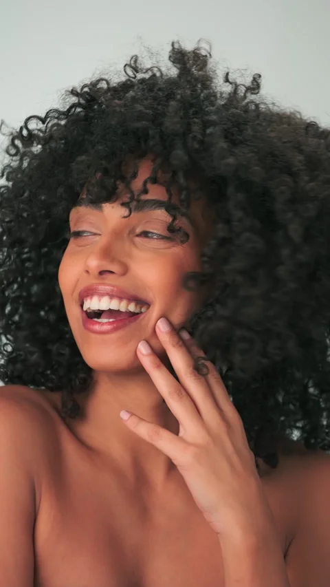 Vertical portrait of young smiling model with curly hair in afro style and Stock Footage 277446795