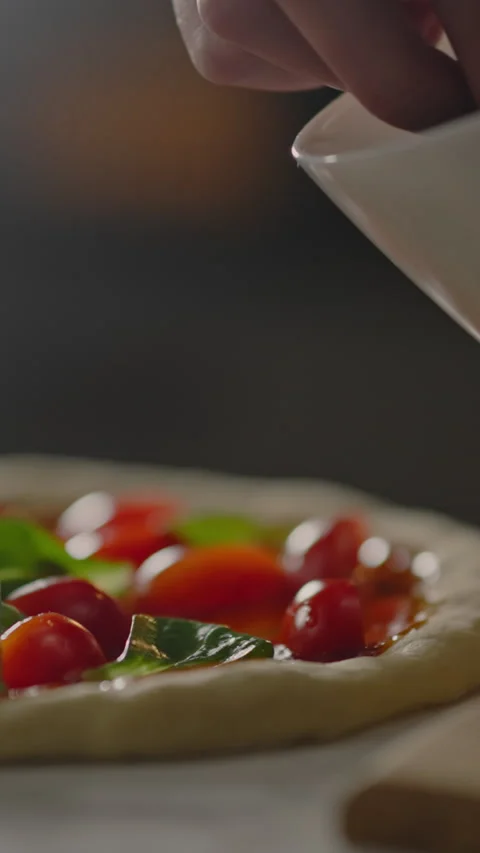 Vertical position. At an Italian pizzeria, the wait staff professionally add Stock Footage 331735741