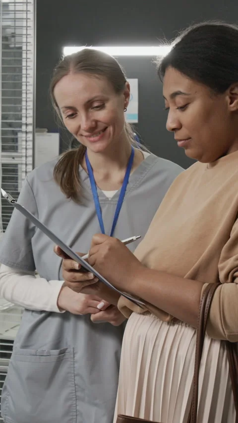 Vertical of Positive IVF Physician Watching Client Signing Service Agreement Stock Footage 333683312