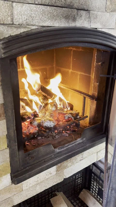 Vertical - Potatoes Wrapped In Foil Baking In Fireplace Hot Embers Stock Footage 345250529