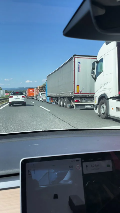 VERTICAL, POV: Driving along a sunny highway, passing a long line of trucks Stock Footage 334010247