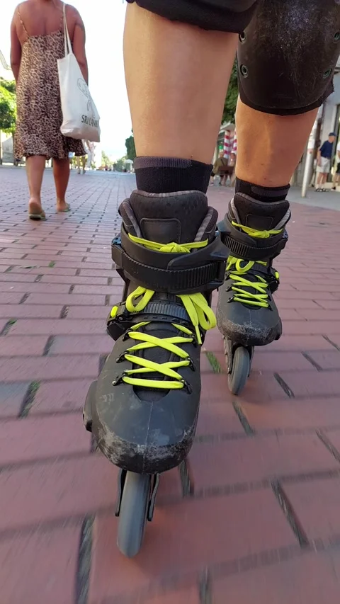 Vertical POV facing backward inline skating red brick tiles ASMR sound 4K UHD Stock Footage 344930421