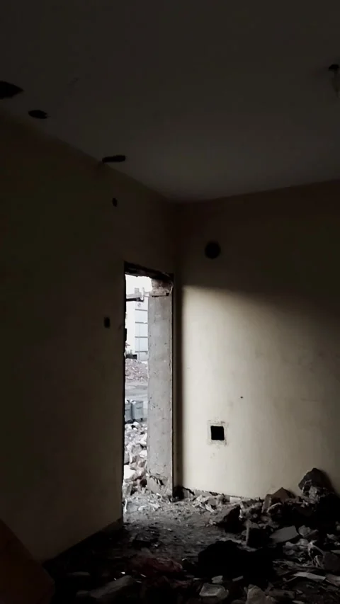 Vertical POV shot from inside a dark demolished building looking out at rubb Stock-Footage 328402521