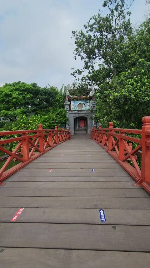 Vertical POV Shot Walking Across Iconic Red Huc Bridge in Hanoi, Vietnam. Stock Footage 319019983