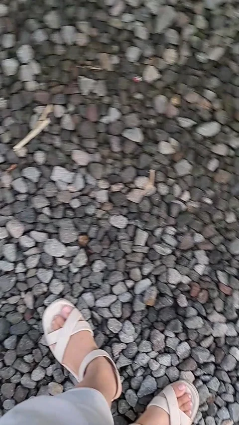 Vertical POV Standing on Stone Pebbles Stock Footage 331417207