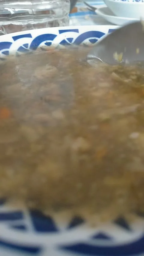 Vertical POV Stirring Freshly Prepared Vegetable Soup with Steam 스톡 동영상 333076552