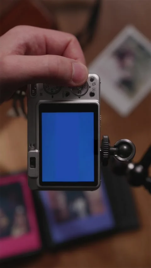 Vertical POV of vintage silver camera with blue screen for mockup Stock Footage 333765053