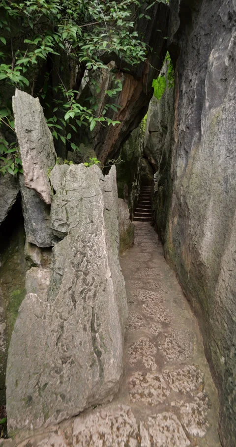 Vertical POV, walking through narrow path at Shilin Stone Forest Stock Footage 329622357