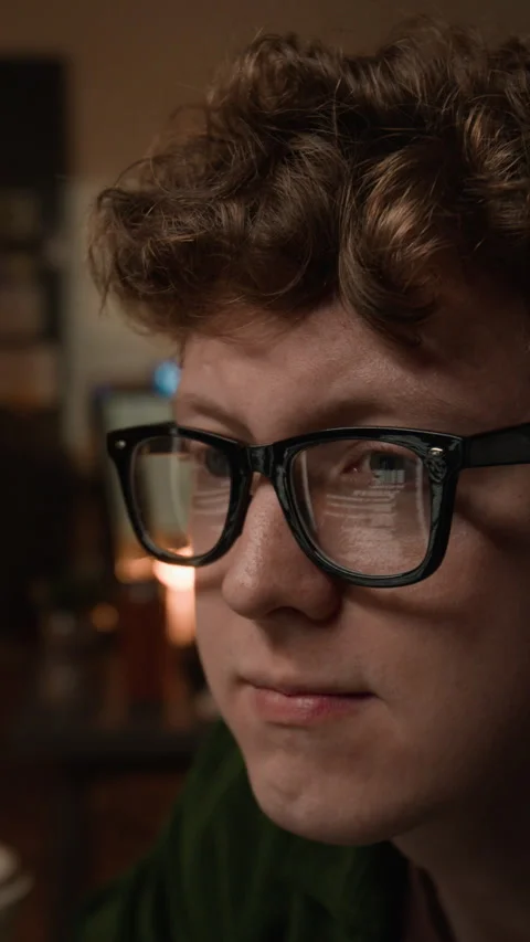 Vertical of Programmer Wearing Glasses with Code Reflection Working on Computer 動画素材 336716792