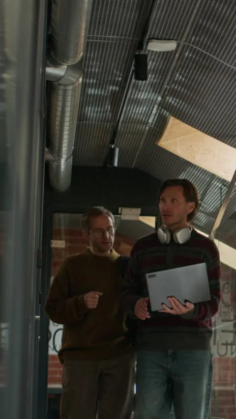 Vertical of Programmers Discussing Ideas for Future Startup in Office Corridor Stock Footage 319993318