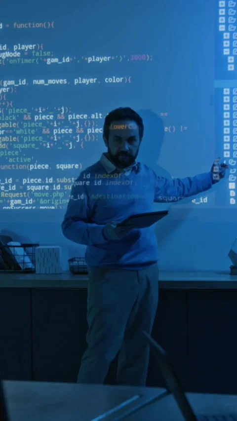 Vertical of Programming Teacher Explaining Algorithm in Blue Projector Light Stock Footage 307091358