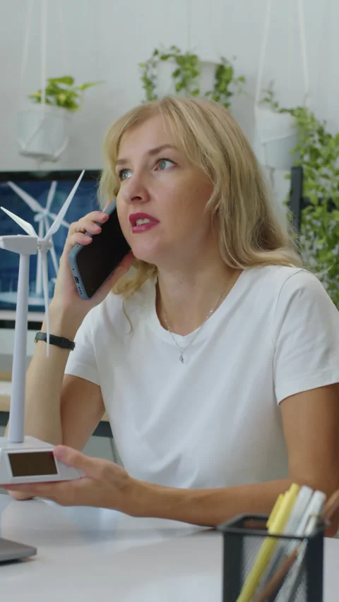Vertical of Project Manager Calling on Phone and Holding Wind Turbine Model Stock Footage 277152959