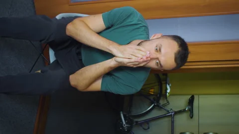 Vertical protrait man feeling sad and depressed, covers face with hands, sitting Stock Footage 168690438
