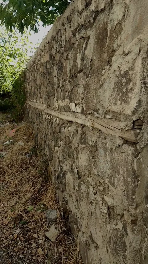 Vertical pull-back shot revealing an old wooden door with peeling white pain Stock-Footage 328402459