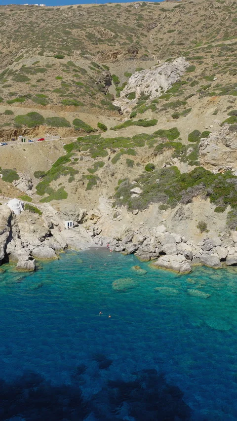 Vertical pullback of Agia Anna beach with swimmers, Amorgos Island Stock Footage 315845227