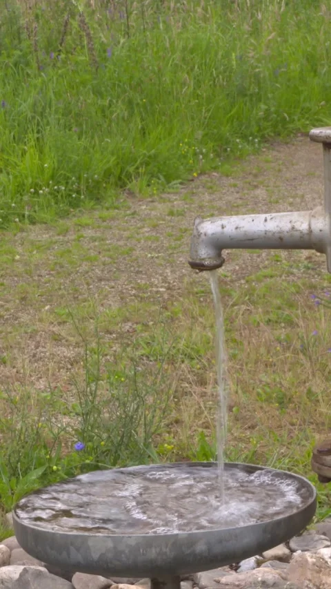 Vertical - Pumping up groundwater by hand using a traditional pump. Stock Footage 309084252