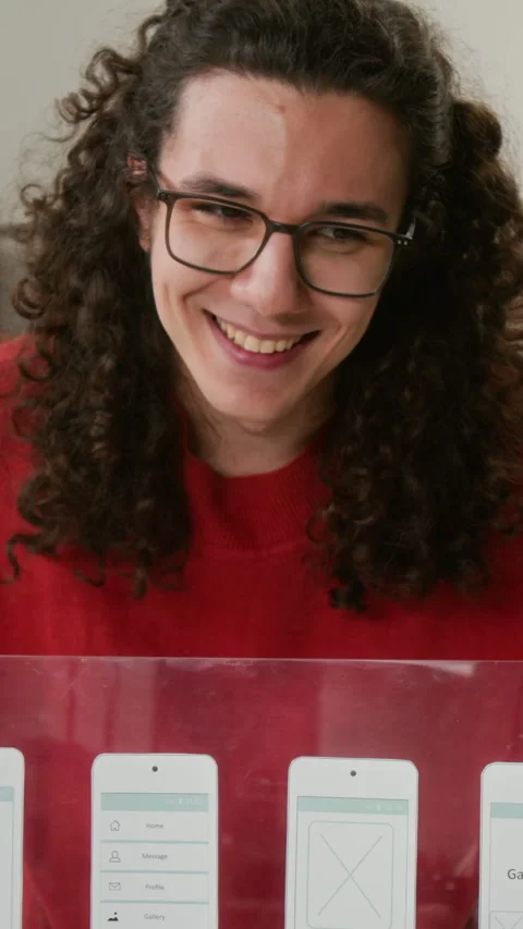 Vertical of Quirky Male UI Developer Presenting Wireframes to Project Team Stock Footage 327897643