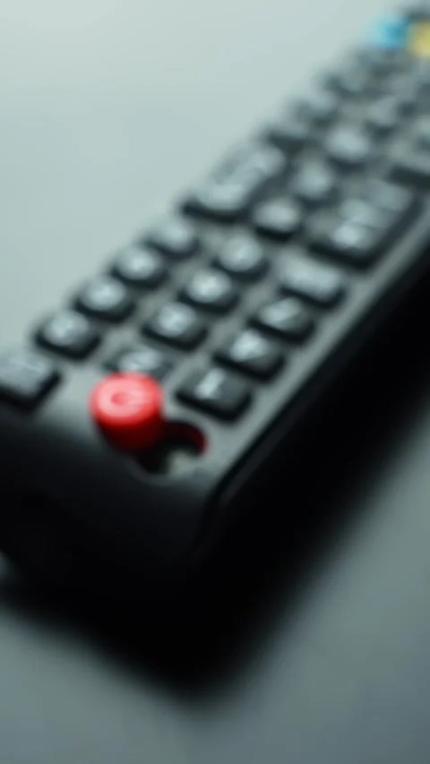 Vertical rack-focus shot from sharp macro on a red power button to a wider 스톡 동영상 329611792