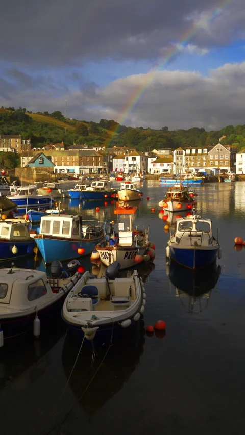 Vertical - Rainbow above a sunlit scenic old boat harbour, in Cornwall, England. Stock Footage 287312341