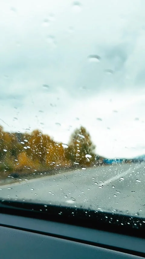 Vertical raindrops on car windshield while driving Stock Footage 320897111