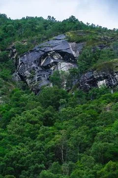 Vertical realistic view of powerful waterfall falling from mountains in Norwa Foto stock