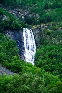 Vertical realistic view of powerful waterfall falling from mountains in Norwa Foto stock