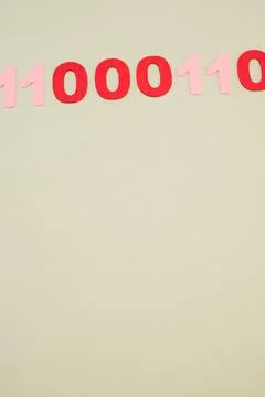 Vertical of red and pink binary codes on a white surface Stock Photos