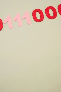 Vertical of red and pink binary codes on a white surface Stock Photos