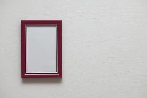 Vertical red plastic frame on indoor white wall Stock Photos
