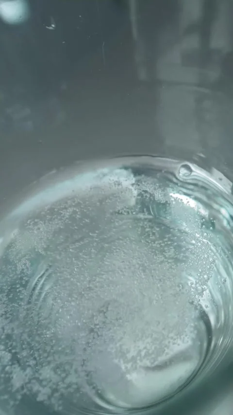 Vertical of Reflection of sick man throwing pill into glass of water Stock Footage 274155935