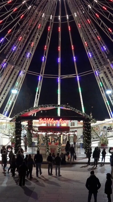 Vertical resolution shot of german Christmas market with big Ferris Wheel Stock Footage 116549135