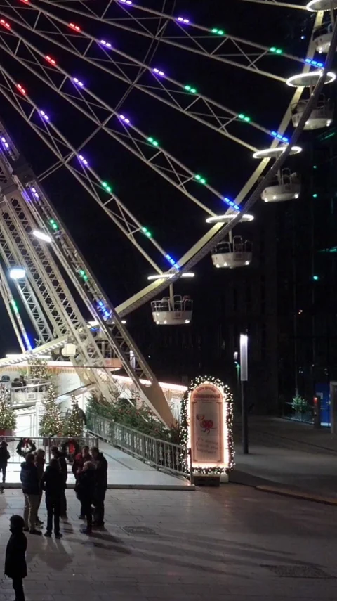 Vertical resolution shot of german Christmas market with big Ferris Wheel Stock Footage 116549830