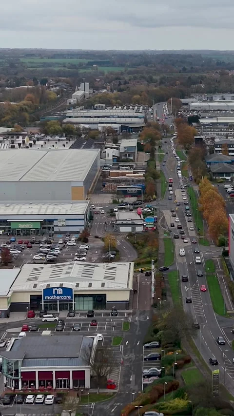 Vertical reversing drone shot over Temple Mills Retail Park in Harlow, Essex Stock Footage 321437508