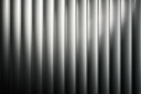 Vertical ridged metal wall texture shows soft studio light gradient, minimal 스톡 사진