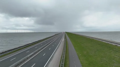 Vertical rise above endless dam fading into cloudy horizon Stock Footage 331829081