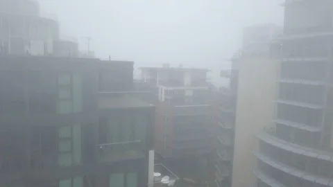 Vertical Rise and Fly Over Luxury Apartments on Foggy Day Stock Footage 103469558