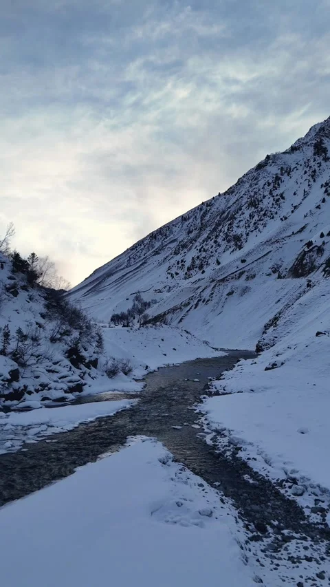 Vertical river in snow covered moutains Video stock 327690992