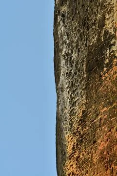 Vertical rock cliff with blue sky background pattern structure 写真素材