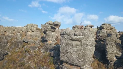 Vertical rock formations in the grass horizontal pan medium shot Stock Footage 78584394