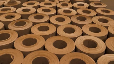 Vertical rolls of kraft paper stand in production for shipment to the store Stock Footage 297817580