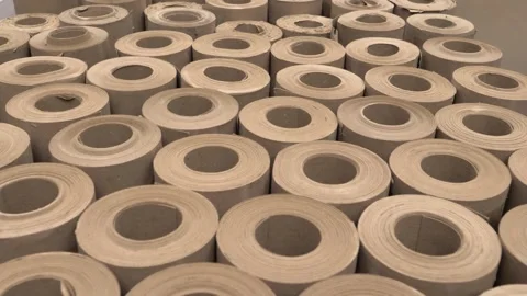 Vertical rolls of kraft paper stand in production for shipment to the store Stock Footage 297817596