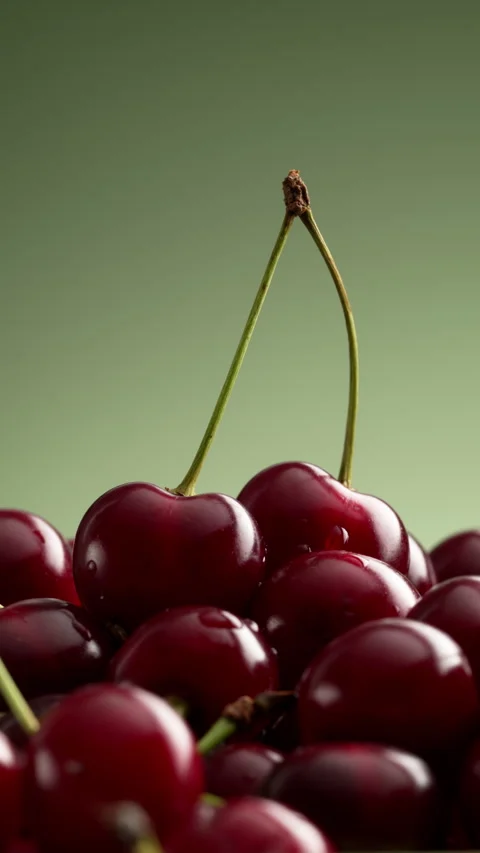 Vertical rotating cherries with hero pair on top. Stock Footage 328985826