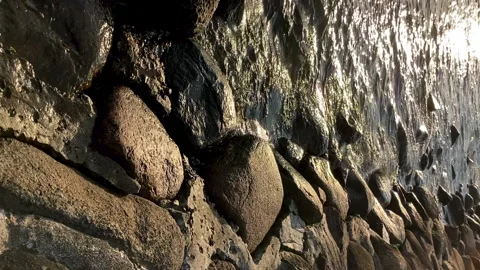 Vertical: Rounded stones lying on sea shore, calm water. Baltic sea Video stock 233354655