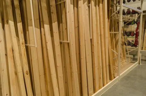 A vertical row of boards in a hardware store. Wooden products for construction Stock Photos