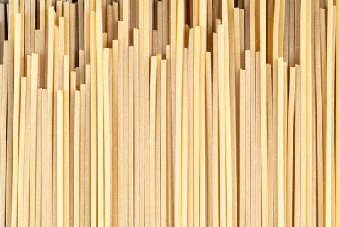 Vertical rows of dry spaghetti pasta forming abstract texture Stock Photos